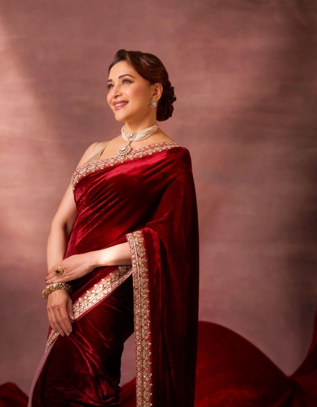 Madhuri redefines timeless glamour with a messy yet polished updo, styled with one-sided waves at the crown. Proof that festive hairstyles can be both graceful and glamorous.